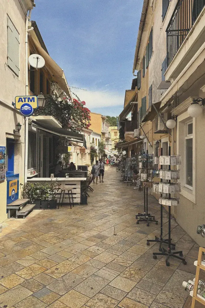 A bustling main street in Gaios lined with local shops and cafes, inviting visitors to explore